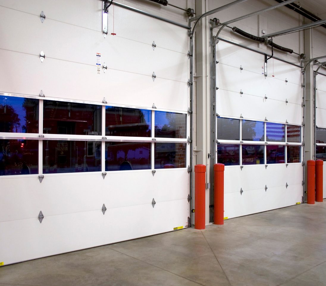 Commercial sectional overhead garage doors at a warehouse loading bay