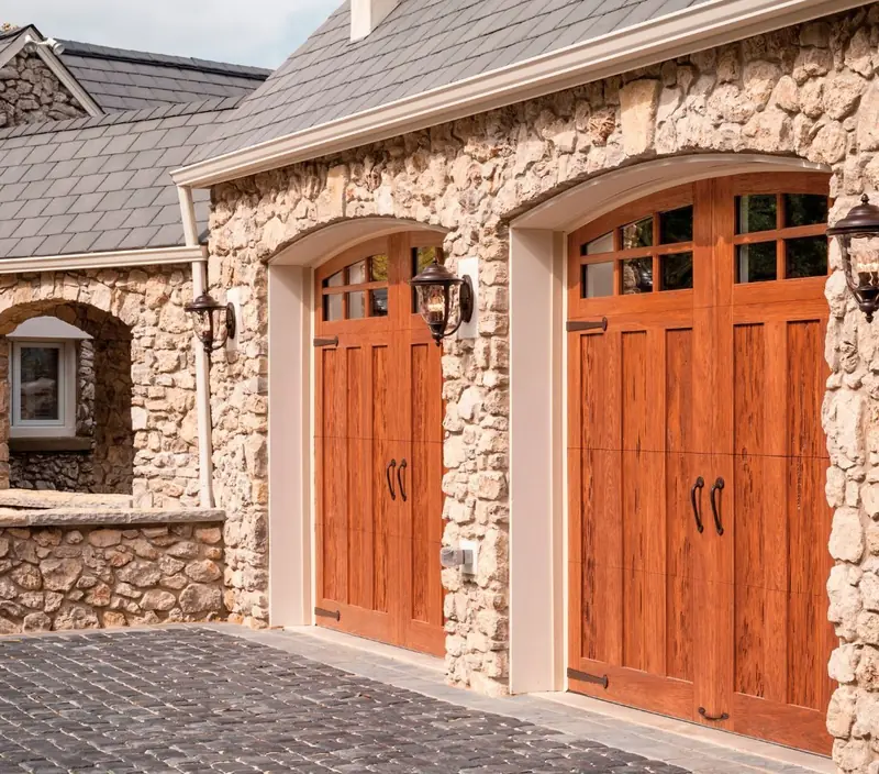 Custom wood carriage-style garage doors on a two-car garage